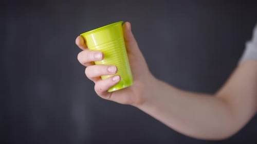 Hand Squeezing Green Plastic Cup
