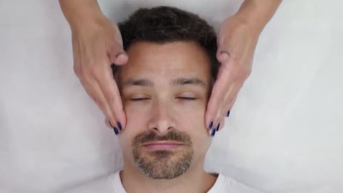 Man Receiving Relaxing Facial Massage at Spa