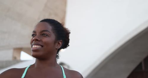 Fit african girl smiling in the city after sport workout