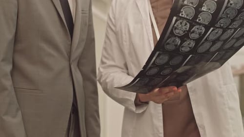 Medical Workers Looking at Patient Brain Xray