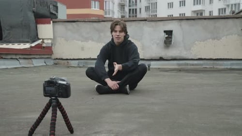 Handsome Reporter Shooting a Video By Himself on the Street Roof