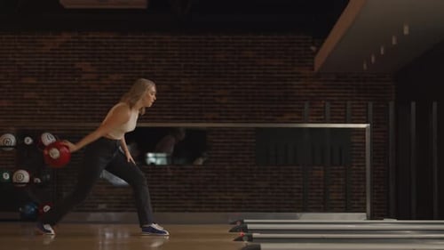 Alone Caucasian Blonde Woman Throws a Bowling Ball and Knocks Out a Shoot with One Throw Dances