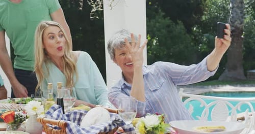 Playful Family Taking Pictures at Backyard Picnic