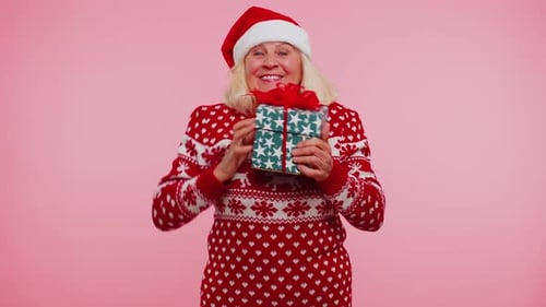 Excited Senior Woman Receiving Christmas Gift