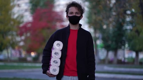 Young Adult Holding Toilet Paper Wearing a Mask