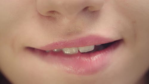 Woman Bites Lip in Extreme Close Up