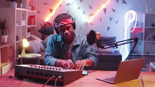 Young Man Making Music at his Home Studio