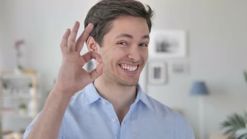 Man Smiling and Giving OK Hand Gesture