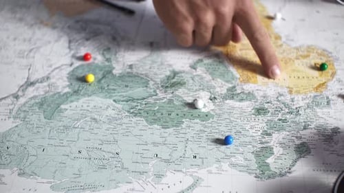 Fingers Pointing to Travel Route on a Map