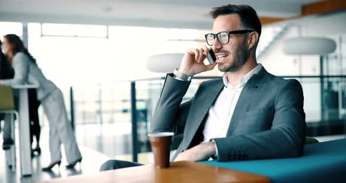 Businessman Talking on Cellphone at Modern Workplace