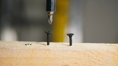 Drilling a Black Screw into a Wood Plank