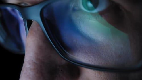 Extreme Close Up of Eyeglasses With Screen Reflection