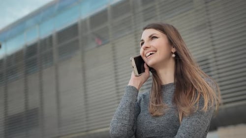 Young Woman Using Smartphone in Urban Setting