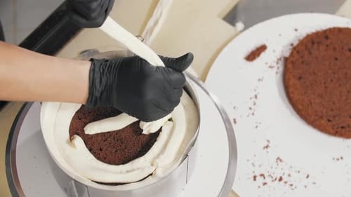 Chef Decorates Cake With White Cream Frosting