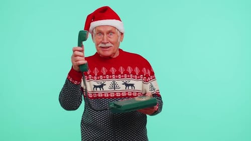 Senior Man in Santa Hat on Christmas Phone