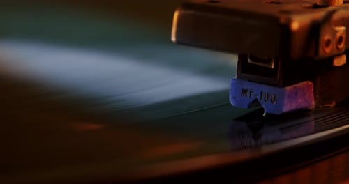 Vinyl Record Player Turntable with Its Stylus Running Along Music Plate. Neon Light. Close Up
