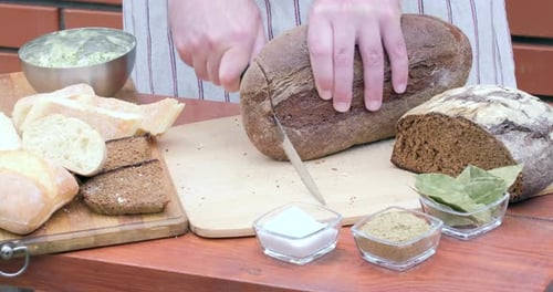 Cutting crusty bread with a knife