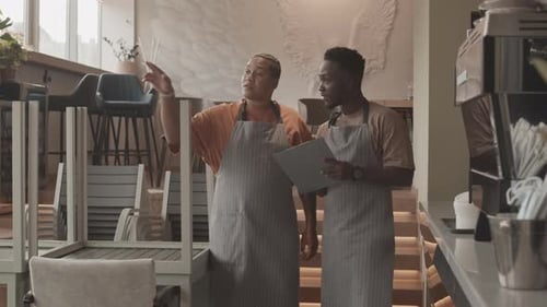 Cafe Workers Discussing Tasks for Day