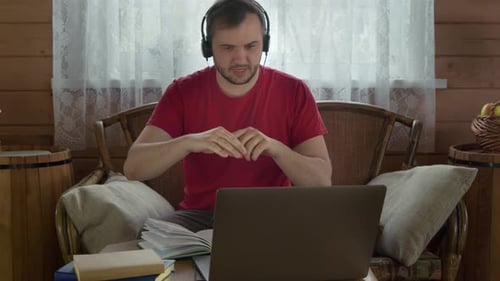 Young Adult in Video Call on Laptop Indoors
