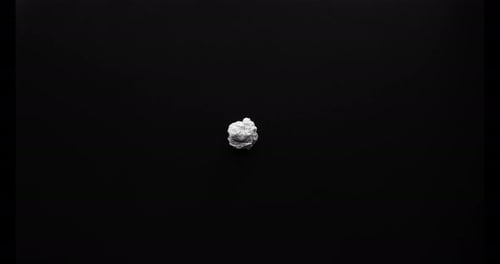 Paper Unfolding Stop Motion on a Black Surface