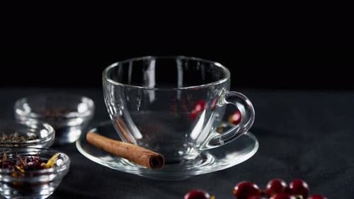 Close Up of a Cup with Cinnamon and Dry Tea on the Side, Teapot,