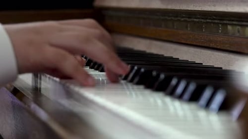Child playing piano. Close up