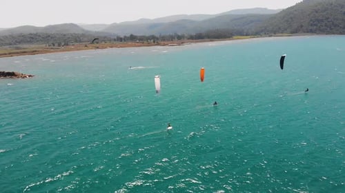 Kitesurfers Gliding across Azure Ocean Bay