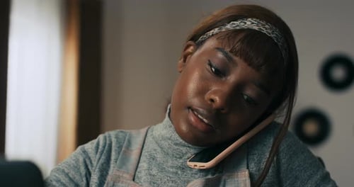 Woman Talking on the Phone at Home Office