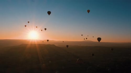 Hot Air Balloons Floating Over the Landscape at Sunrise