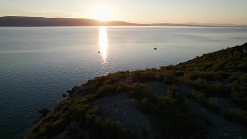 Aerial View of Landscape Sunset Over the Sea Leaves Trail and Glare on the Water
