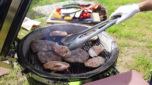 Grilling Meat Outdoors on a Charcoal Grill