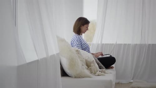 Young Woman Working on Laptop Indoors
