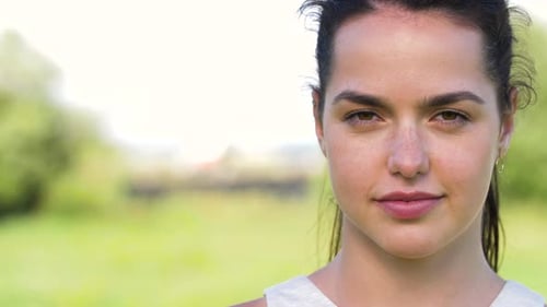Woman Smiling at Camera in Nature