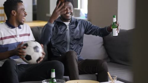 Excited Friends Watch Soccer Game Together at Home