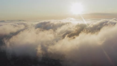 View From a Drone of City Center Above Which Clouds are Rapidly Floating