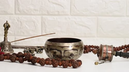 Hand Placing Mallet in Singing Bowl