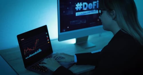 Young Adult Typing on Laptop in Modern Office