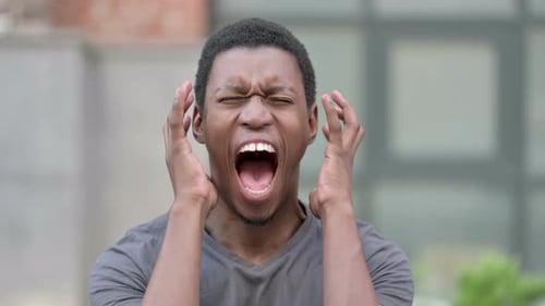 Portrait of Angry Young African Man Shouting, Screaming