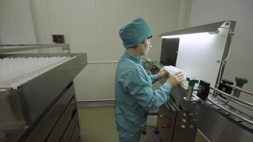 Operator Controls the Quality and Rejects Non-standard Bottles on Medical Solutions Conveyor, Blow