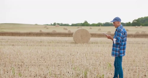 Farmer Using Digital Tablet on Field Agriculture