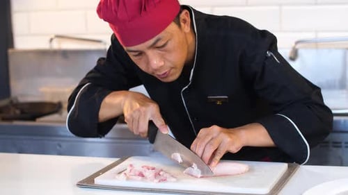 Chef Dicing Fresh Fish in Commercial Kitchen