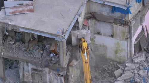 Excavator Demolishes Concrete Building in Urban Setting