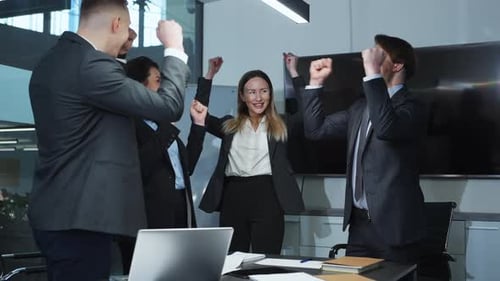 Happy Business Team Raising Hands and Clapping in Office