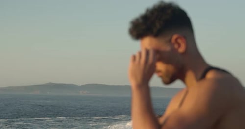 Tranquil man enjoying seascape in summer at sunset