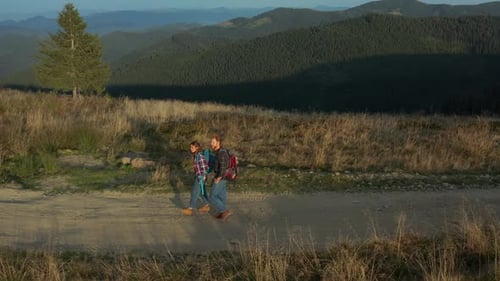 Drone Tourists Backpacks Walking Mountains Path Talking Against Green Hills