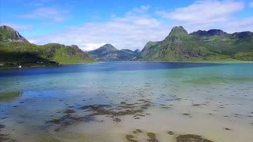 Aerial View of Serene Beach and Mountain Landscape