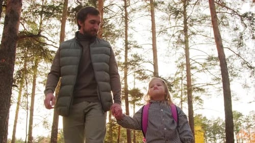 Father and Cute Little Girl Walking in Park