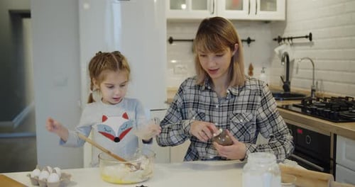 Mother and Child Baking Together in Kitchen