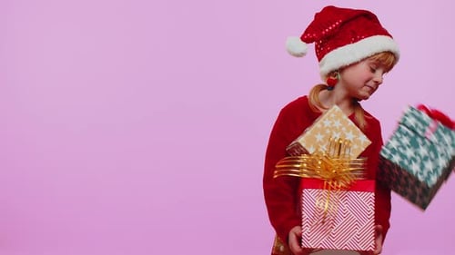 Smiling Girl Holds Christmas Gifts with Delight