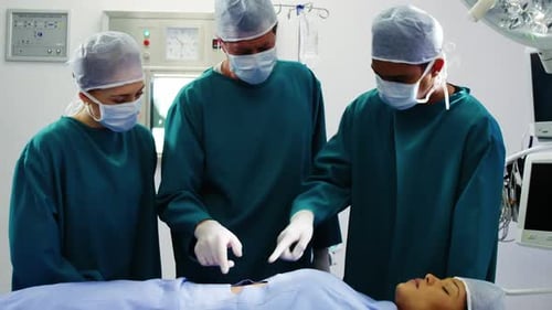 Healthcare Workers Attend to Patient in Operating Room